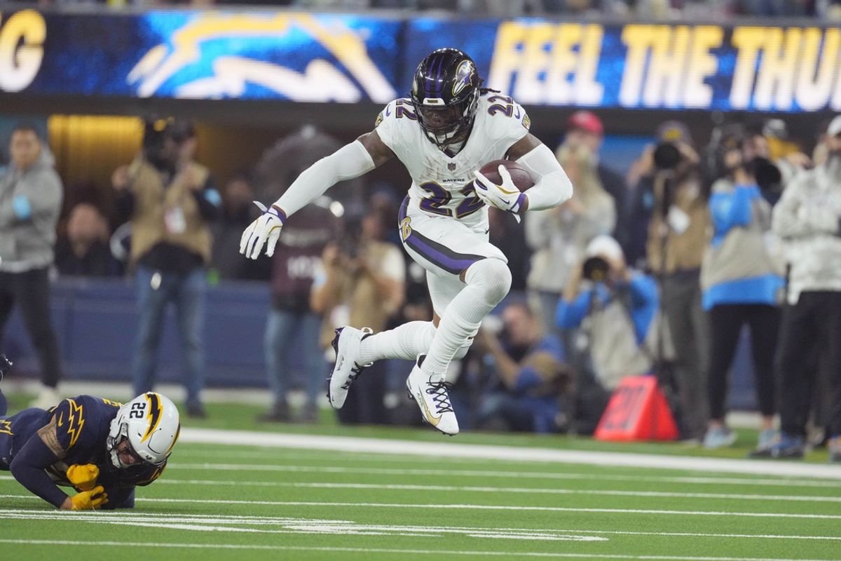 Baltimore Ravens running back Derrick Henry (22) carries the ball against  cornerback Elijah Molden (22) in the second half at SoFi Stadium. Mandatory Credit: Kirby Lee-Imagn Images