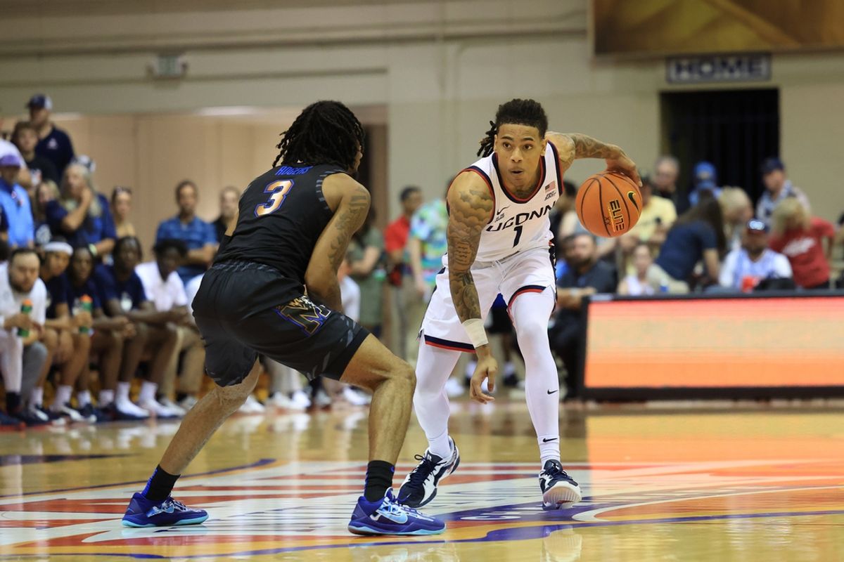 Nov 25, 2024; Lahaina, Hawaii, USA; Connecticut Huskies guard Solo Ball (1) takes on Memphis Tigers guard Colby Rogers (3) during an NCAA college basketball game at Lahaina Civic Center. Mandatory Credit: Marco Garcia-Imagn Images