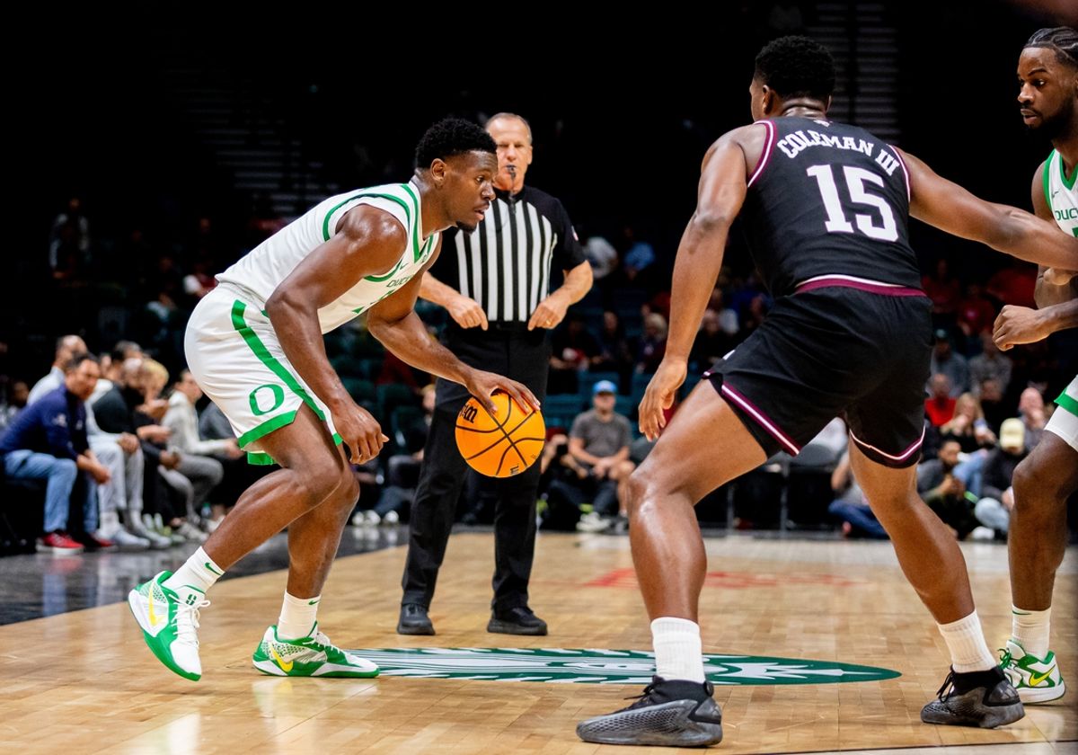 Nov 26, 2024; Las Vegas, Nevada, USA; Oregon Ducks guard TJ Bamba (5) dribbles against Texas A&M Aggies forward Henry Coleman III (15) during the first period at MGM Grand Garden Arena. Mandatory Credit: Jeffrey (Tyge) O'Donnell-Imagn Images