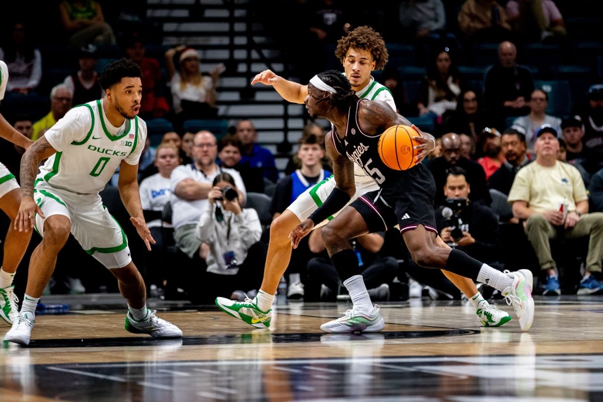 Nov 26, 2024; Las Vegas, Nevada, USA; Texas A&M guard Manny Obaseki (35) dribbles against Oregon Ducks guard Ra'Heim Moss (0) during the first half at MGM Grand Garden Arena. Mandatory Credit: Jeffrey (Tyge) O'Donnell-Imagn Images