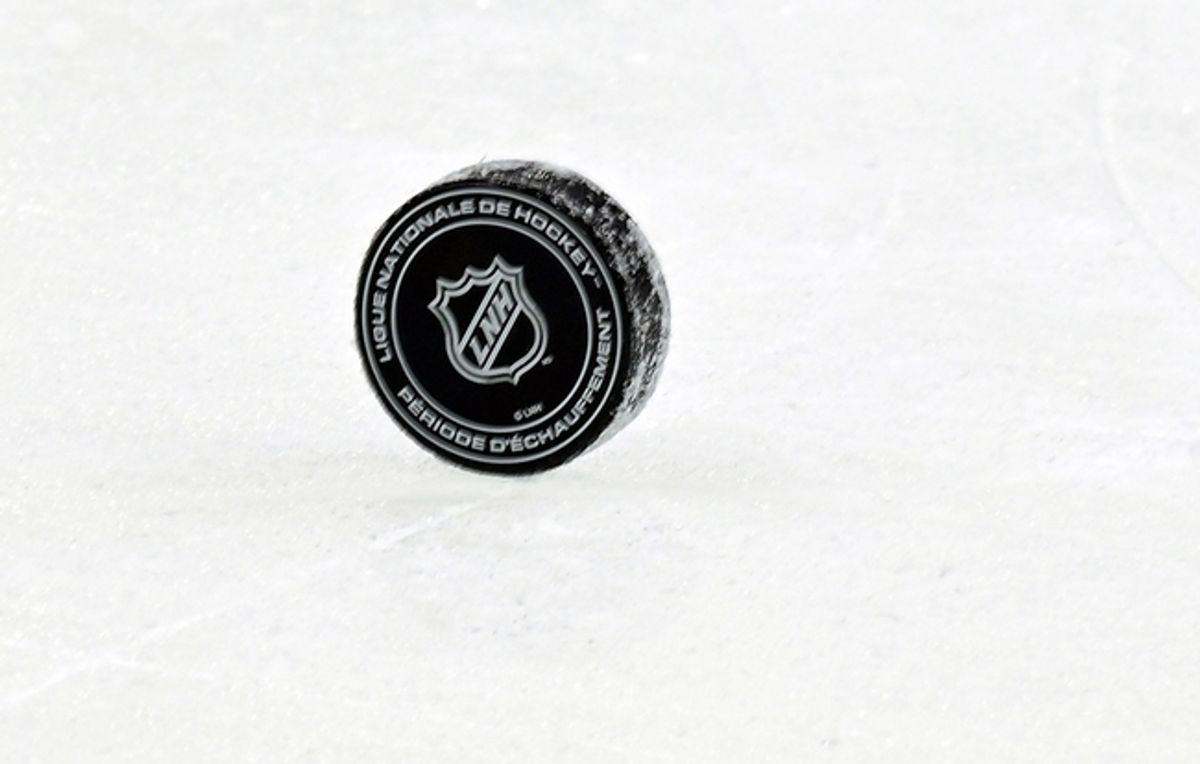 Nov 26, 2024; Montreal, Quebec, CAN; NHL puck with French logo during the warmup period before a game between the Utah Hockey Club and the Montreal Canadiens at the Bell Centre. Mandatory Credit: Eric Bolte-Imagn Images
