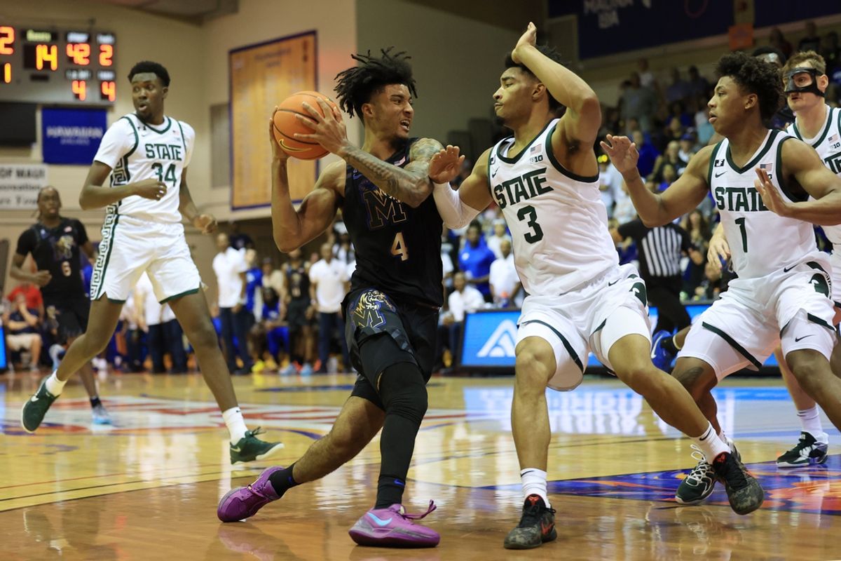 Nov 26, 2024; Lahaina, Hawaii, USA;  Memphis Tigers guard PJ Haggerty (4) drives against Michigan State Spartans guard Jaden Akins (3) during the first half at Lahaina Civic Center. Mandatory Credit: Marco Garcia-Imagn Images