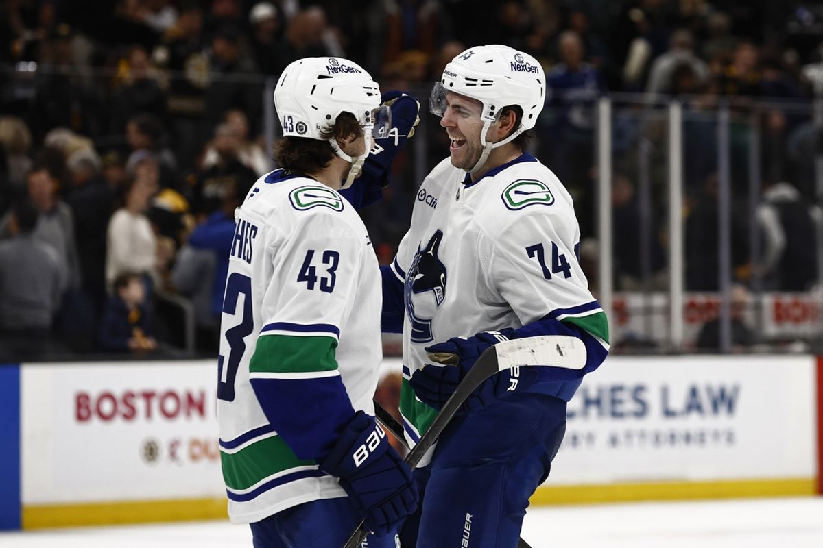 Nov 26, 2024; Boston, Massachusetts, USA; Vancouver Canucks left wing Jake DeBrusk (74) smiles at captain Quinn Hughes (43) after their 2-0 win over the Boston Bruins at TD Garden. Mandatory Credit: Winslow Townson-Imagn Images