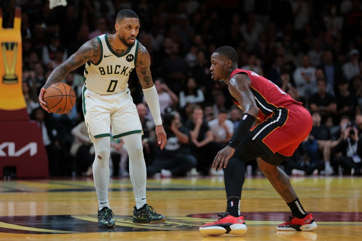 Nov 26, 2024; Miami, Florida, USA; Milwaukee Bucks guard Damian Lillard (0) dribbles the basketball as Miami Heat guard Terry Rozier (2) defends during the fourth quarter at Kaseya Center. Mandatory Credit: Sam Navarro-Imagn Images