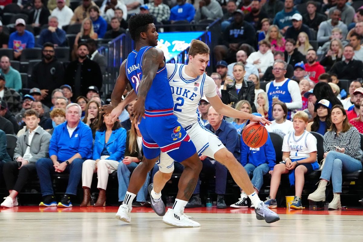 Nov 26, 2024; Las Vegas, Nevada, USA; Duke Blue Devils guard Cooper Flagg (2) dribbles against Kansas Jayhawks forward KJ Adams Jr. (24) during the first half at T-Mobile Arena. Mandatory Credit: Stephen R. Sylvanie-Imagn Images