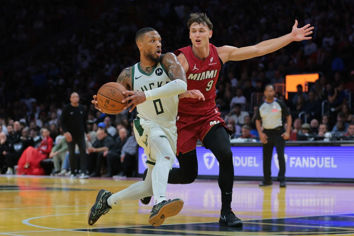 Nov 26, 2024; Miami, Florida, USA; Milwaukee Bucks guard Damian Lillard (0) drives to the basket against Miami Heat guard Pelle Larsson (9) during the third quarter at Kaseya Center. Mandatory Credit: Sam Navarro-Imagn Images