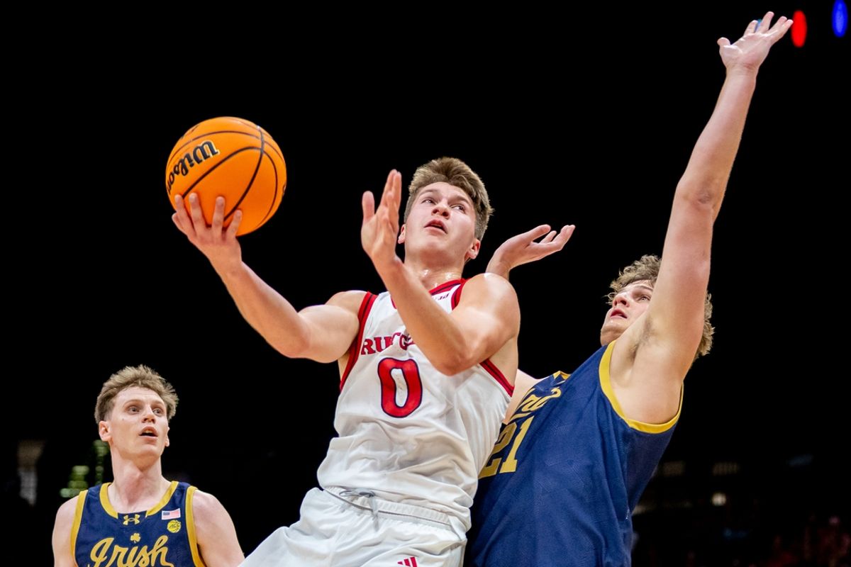 Nov 26, 2024; Las Vegas, Nevada, USA; Rutgers Scarlet Knights guard JOrdan Derkack (0) shoots over Notre Dame Fighting Irish forward Burke Chebuhar (21) during the first half at MGM Grand Garden Arena. Mandatory Credit: Jeffrey (Tyge) O'Donnell-Imagn Images