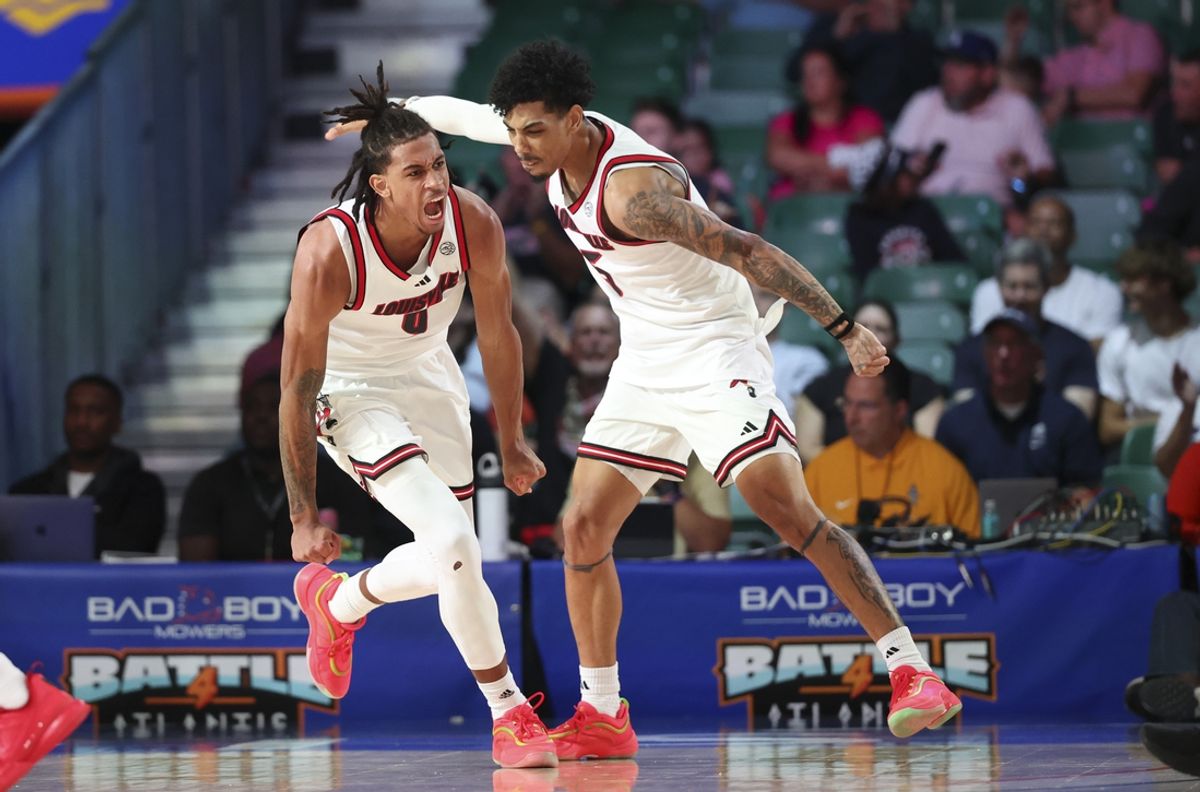 Nov 27, 2024; Paradise Island, Bahamas, BHS; Louisville Cardinals forward Khani Rooths (9) reacts with Louisville Cardinals guard Terrence Edwards Jr. (5) after scoring during the second half against the Indiana Hoosiers at the Atlantis Resort.  Mandatory Credit: Kevin Jairaj-Imagn Images