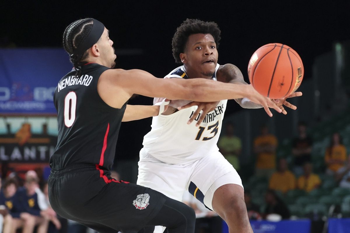 Nov 27, 2024; Paradise Island, Bahamas, BHS; West Virginia Mountaineers forward Amani Hansberry (13) passes the ball as Gonzaga Bulldogs guard Ryan Nembhard (0) defends during the first half at the Atlantis Resort.  Mandatory Credit: Kevin Jairaj-Imagn Images
