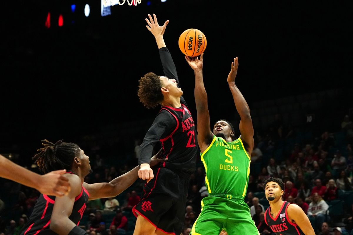 Nov 27, 2024; Las Vegas, Nevada, USA; Oregon Ducks guard TJ Bamba (5) shoots against San Diego State Aztecs guard Miles Byrd (21) during the first half at MGM Grand Garden Arena. Mandatory Credit: Stephen R. Sylvanie-Imagn Images