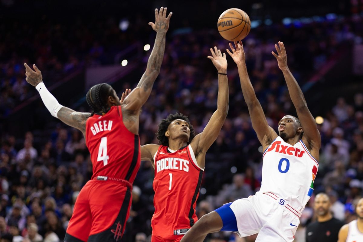 Nov 27, 2024; Philadelphia, Pennsylvania, USA; Houston Rockets guard Jalen Green (4) and forward Amen Thompson (1) Philadelphia 76ers guard Tyrese Maxey (0) shoots the ball in front of  during the first quarter at Wells Fargo Center. Mandatory Credit: Bill Streicher-Imagn Images