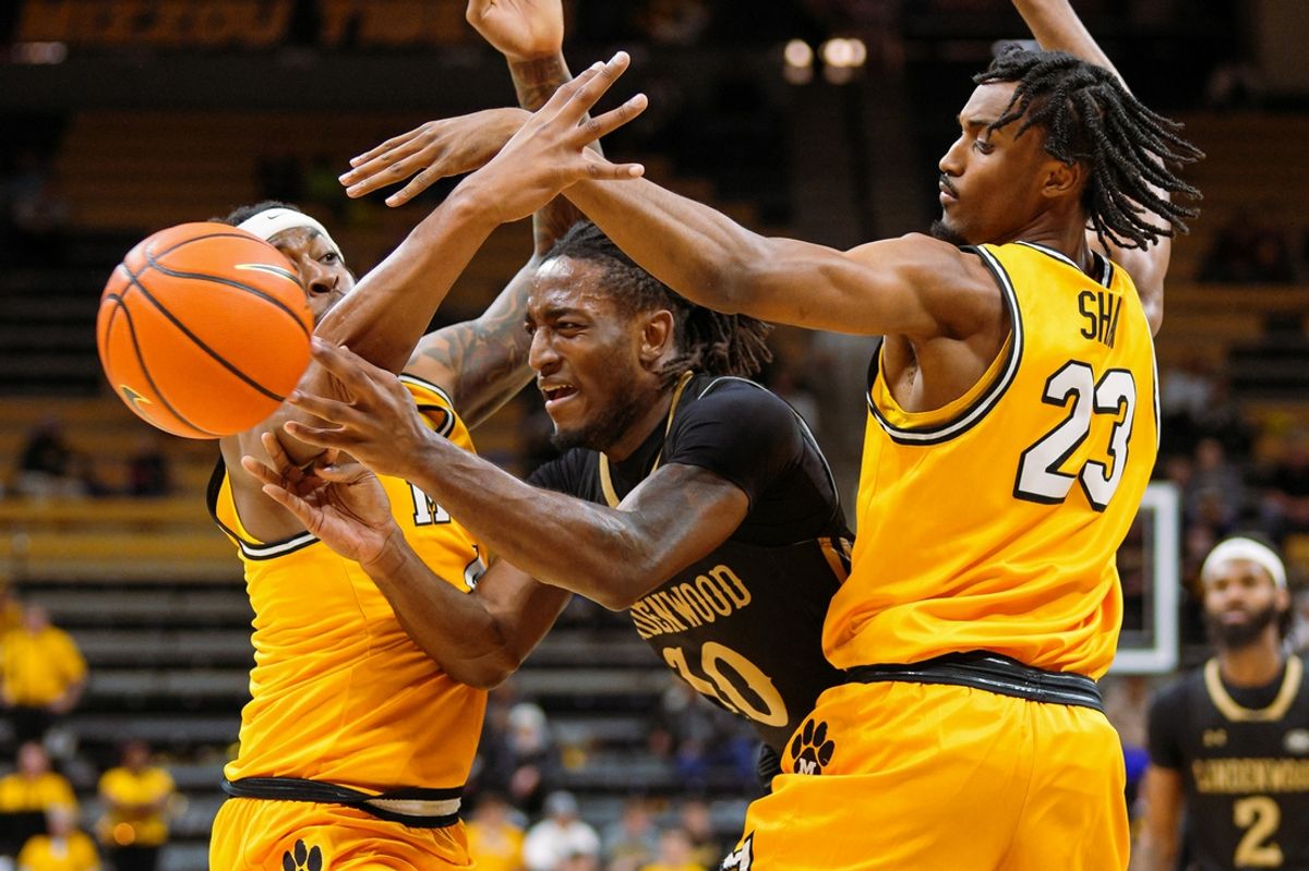 Nov 27, 2024; Columbia, Missouri, USA; Lindenwood Lions guard Jadis Jones (10) passes the ball against Missouri Tigers guard Marcus Allen (4) and guard Aidan Shaw (23) during the first half at Mizzou Arena. Mandatory Credit: Jay Biggerstaff-Imagn Images