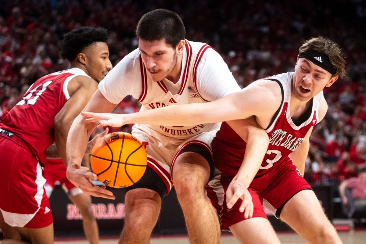 Nov 27, 2024; Lincoln, Nebraska, USA; Nebraska Cornhuskers forward Berke Buyuktuncel (9) and South Dakota Coyotes guard Max Burchill (3) fight for the ball during the first half at Pinnacle Bank Arena. Mandatory Credit: Dylan Widger-Imagn Images