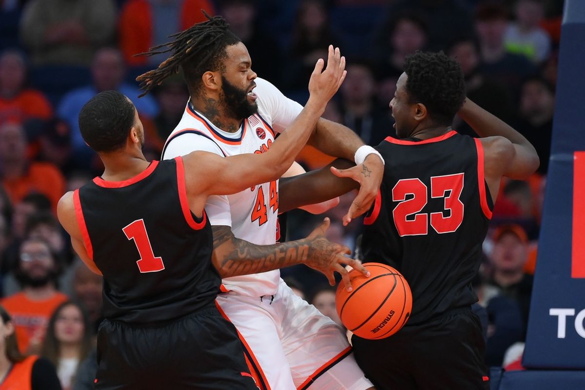 Nov 27, 2024; Syracuse, New York, USA; Cornell Big Red guard Nazir Williams (1), forward DJ Nix (23), and Syracuse Orange center Eddie Lampkin Jr. (44) battle for the ball during the first half at the JMA Wireless Dome. Mandatory Credit: Rich Barnes-Imagn Images