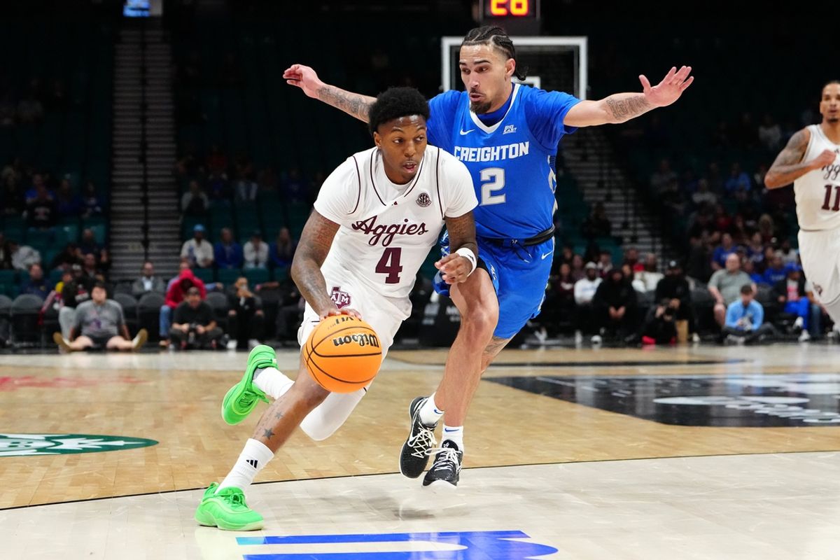 Nov 27, 2024; Las Vegas, Nevada, USA; Texas A&M Aggies guard Wade Taylor IV (4) dribbles against Creighton Bluejays guard Pop Isaacs (2) during the first half at MGM Grand Garden Arena. Mandatory Credit: Stephen R. Sylvanie-Imagn Images