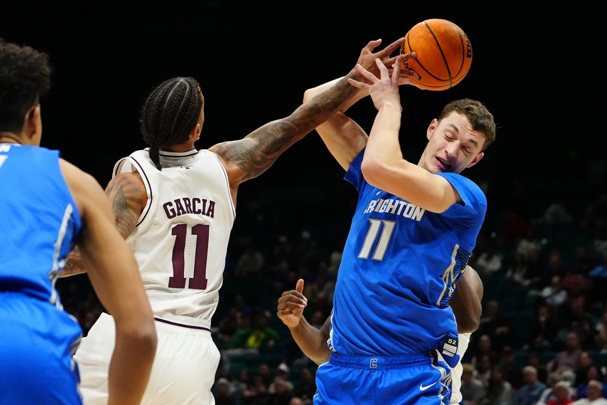 Nov 27, 2024; Las Vegas, Nevada, USA; Texas A&M Aggies forward Andersson Garcia (11) tips the ball away from Creighton Bluejays center Ryan Kalkbrenner (11) during the first half at MGM Grand Garden Arena. Mandatory Credit: Stephen R. Sylvanie-Imagn Images