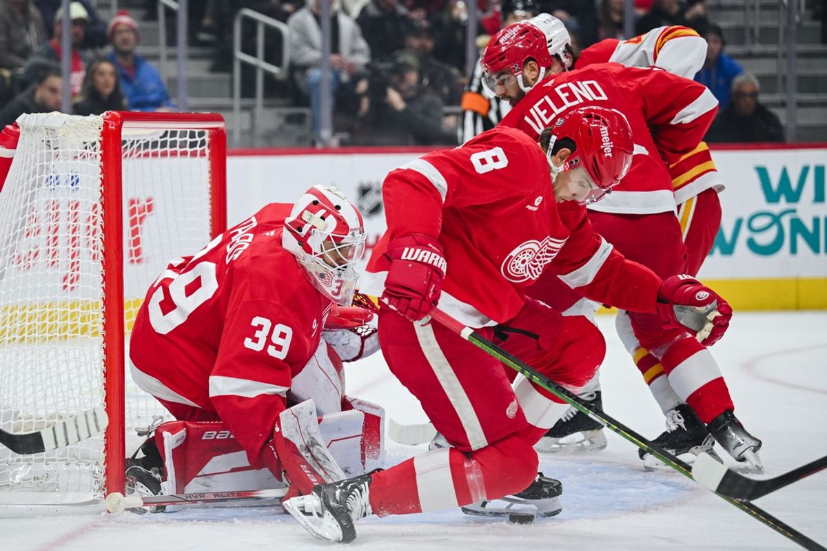 Nov 27, 2024; Detroit, Michigan, USA; Detroit Red Wings defenseman Ben Chart (8) makes a save as goaltender Cam Talbot (39) defends the net during the second period against the Calgary Flames at Little Caesars Arena. Mandatory Credit: Tim Fuller-Imagn Images
