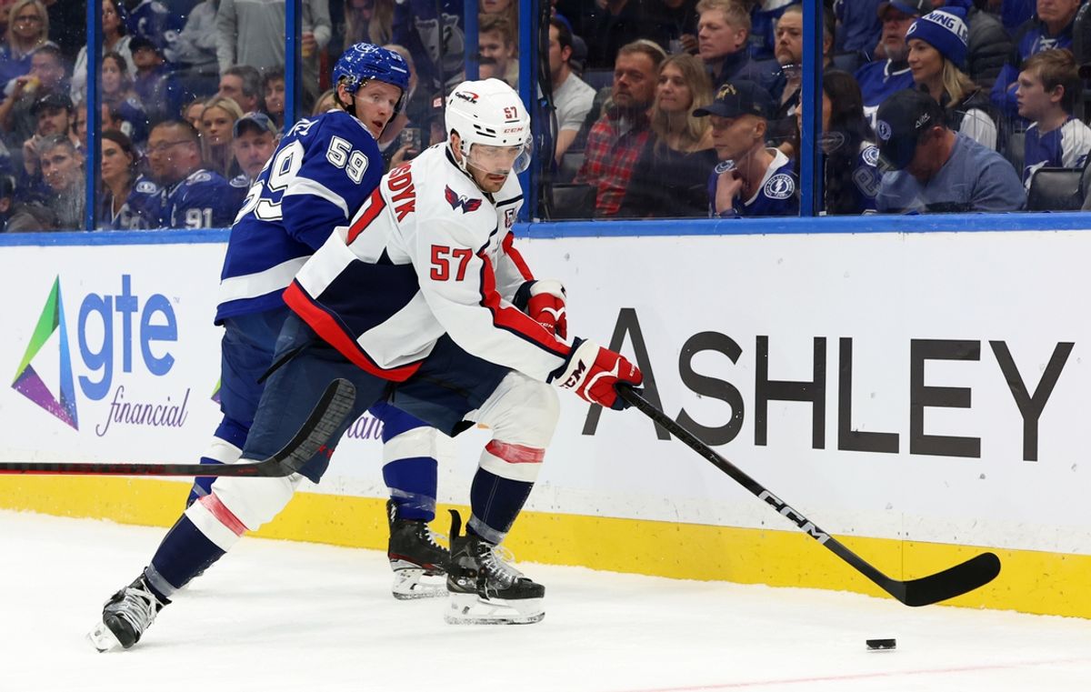 Nov 27, 2024; Tampa, Florida, USA; Washington Capitals defenseman Trevor van Riemsdyk (57) skates with the puck as Tampa Bay Lightning center Jake Guentzel (59) defends during the first period at Amalie Arena. Mandatory Credit: Kim Klement Neitzel-Imagn Images