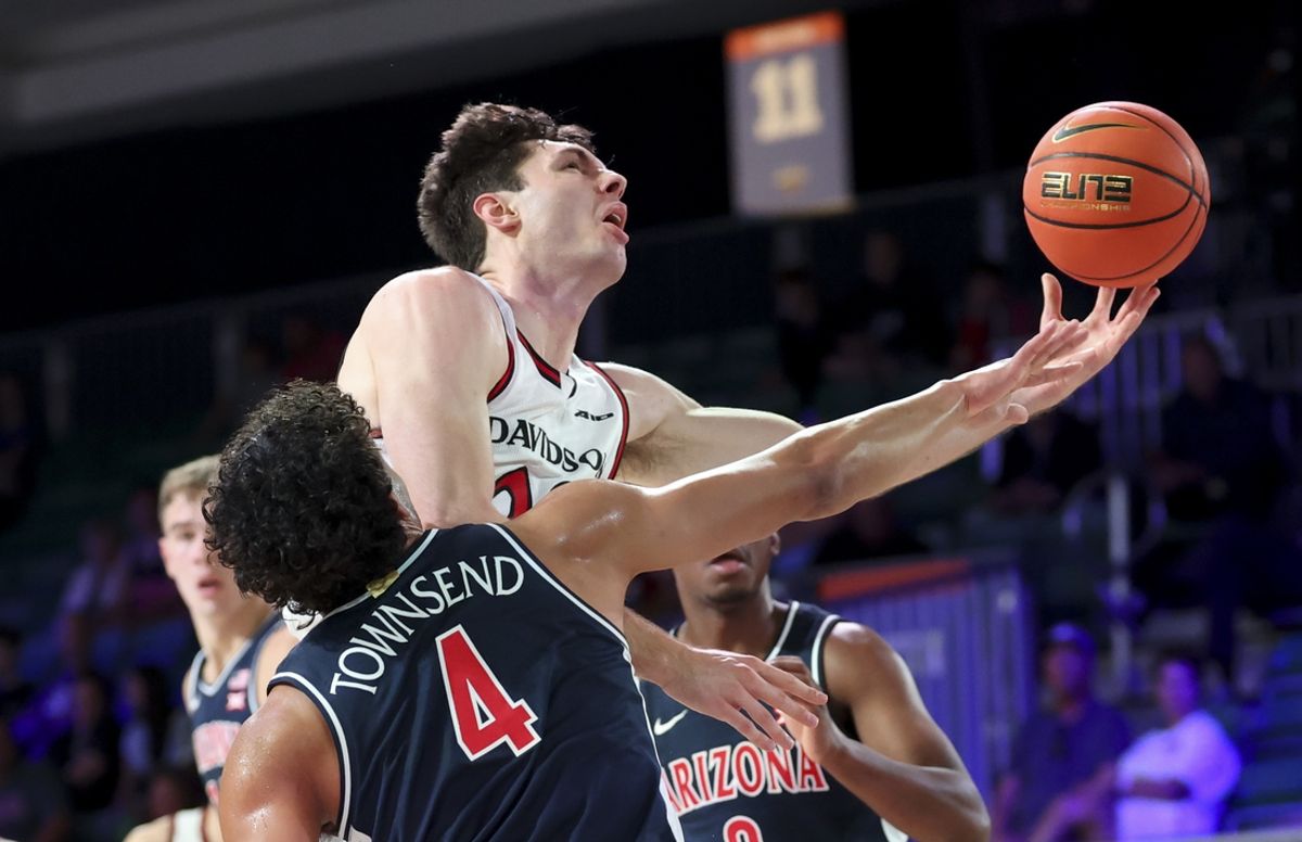 Nov 27, 2024; Paradise Island, Bahamas, BHS; Davidson Wildcats guard Connor Kochera (23) drives to the basket as Arizona Wildcats forward Trey Townsend (4) defends during the first half at the Atlantis Resort.  Mandatory Credit: Kevin Jairaj-Imagn Images