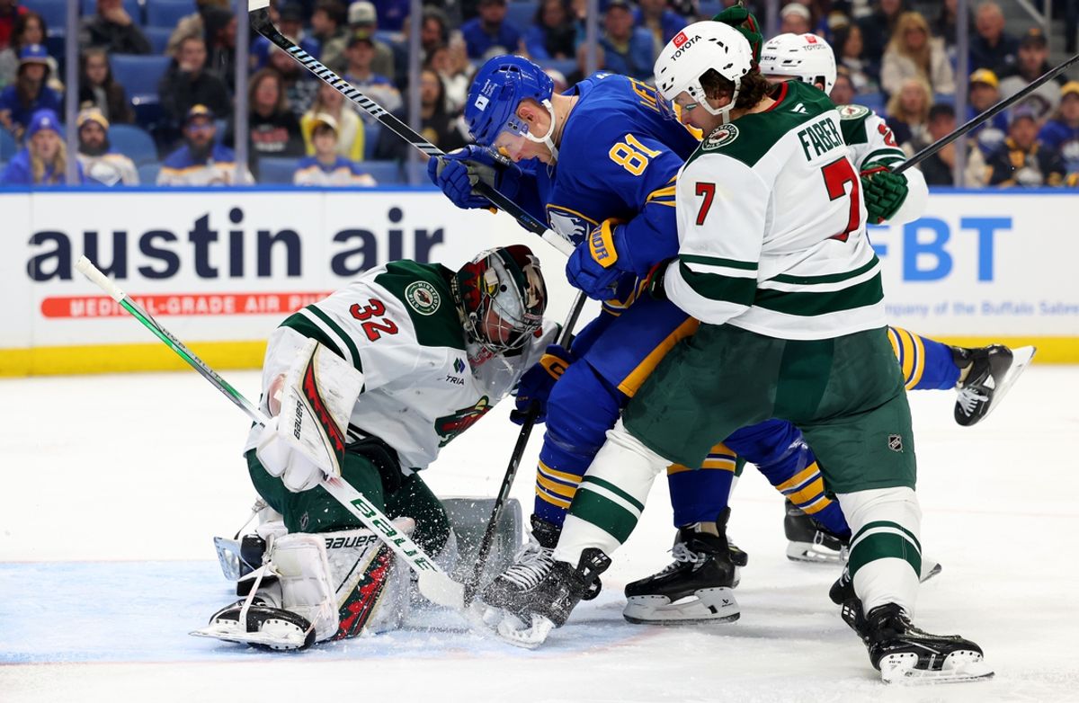 Nov 27, 2024; Buffalo, New York, USA;  Buffalo Sabres center Sam Lafferty (81) looks for a rebound as Minnesota Wild goaltender Filip Gustavsson (32) tries to find the puck mduring the second period at KeyBank Center. Mandatory Credit: Timothy T. Ludwig-Imagn Images