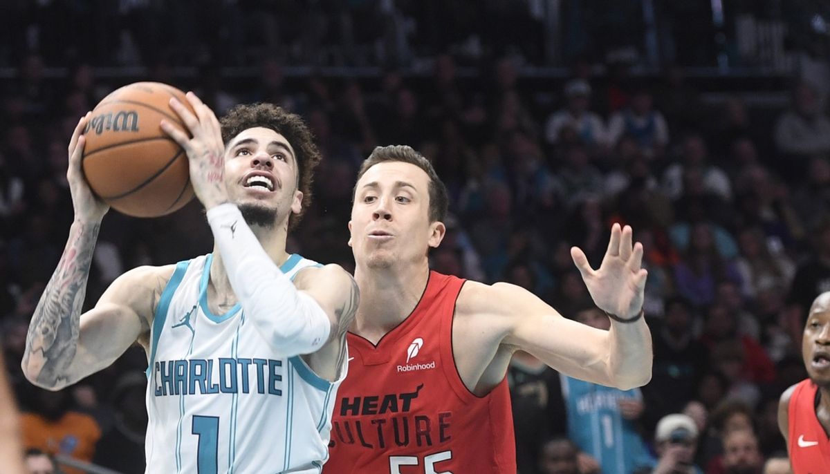Nov 27, 2024; Charlotte, North Carolina, USA;  Charlotte Hornets guard LaMelo Ball (1) looks to shoot as he is defended by Miami Heat guard Duncan Robinson (55) during the second half at the Spectrum Center. Mandatory Credit: Sam Sharpe-Imagn Images