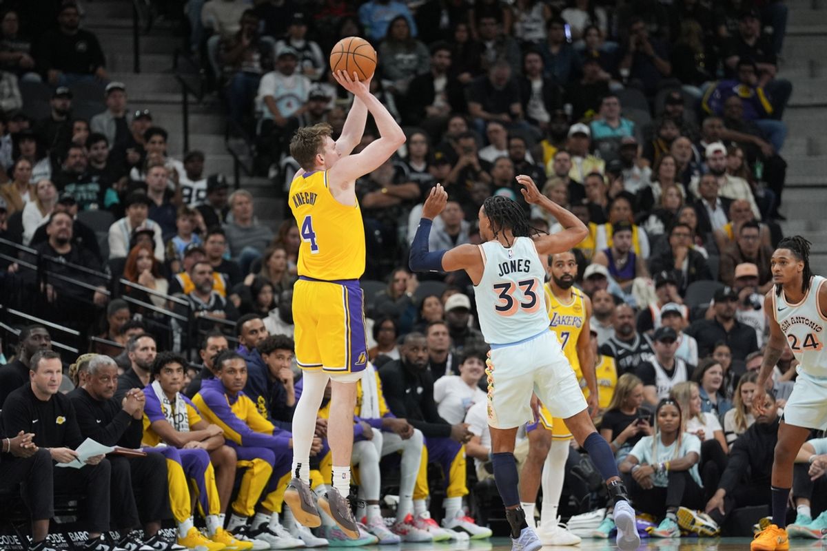 Nov 27, 2024; San Antonio, Texas, USA;  Los Angeles Lakers guard Dalton Knecht (4) shoots over San Antonio Spurs guard Tre Jones (33) in the first half at Frost Bank Center. Mandatory Credit: Daniel Dunn-Imagn Images