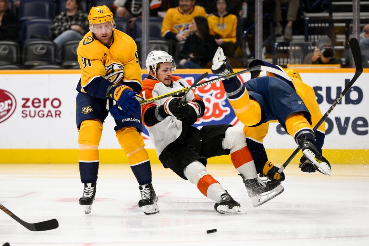 Nov 27, 2024; Nashville, Tennessee, USA;  Nashville Predators center Steven Stamkos (91) and left wing Cole Smith (36) collide with Philadelphia Flyers right wing Tyson Foerster (71) during the second period at Bridgestone Arena. Mandatory Credit: Steve Roberts-Imagn Images