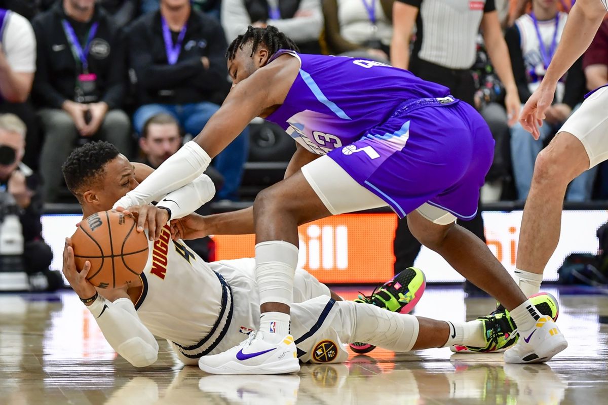 Nov 27, 2024; Salt Lake City, Utah, USA; Denver Nuggets guard Russell Westbrook (4) on the ground battling for the ball with Utah Jazz guard Isaiah Collier (13) during the first half at the Delta Center. Mandatory Credit: Christopher Creveling-Imagn Images