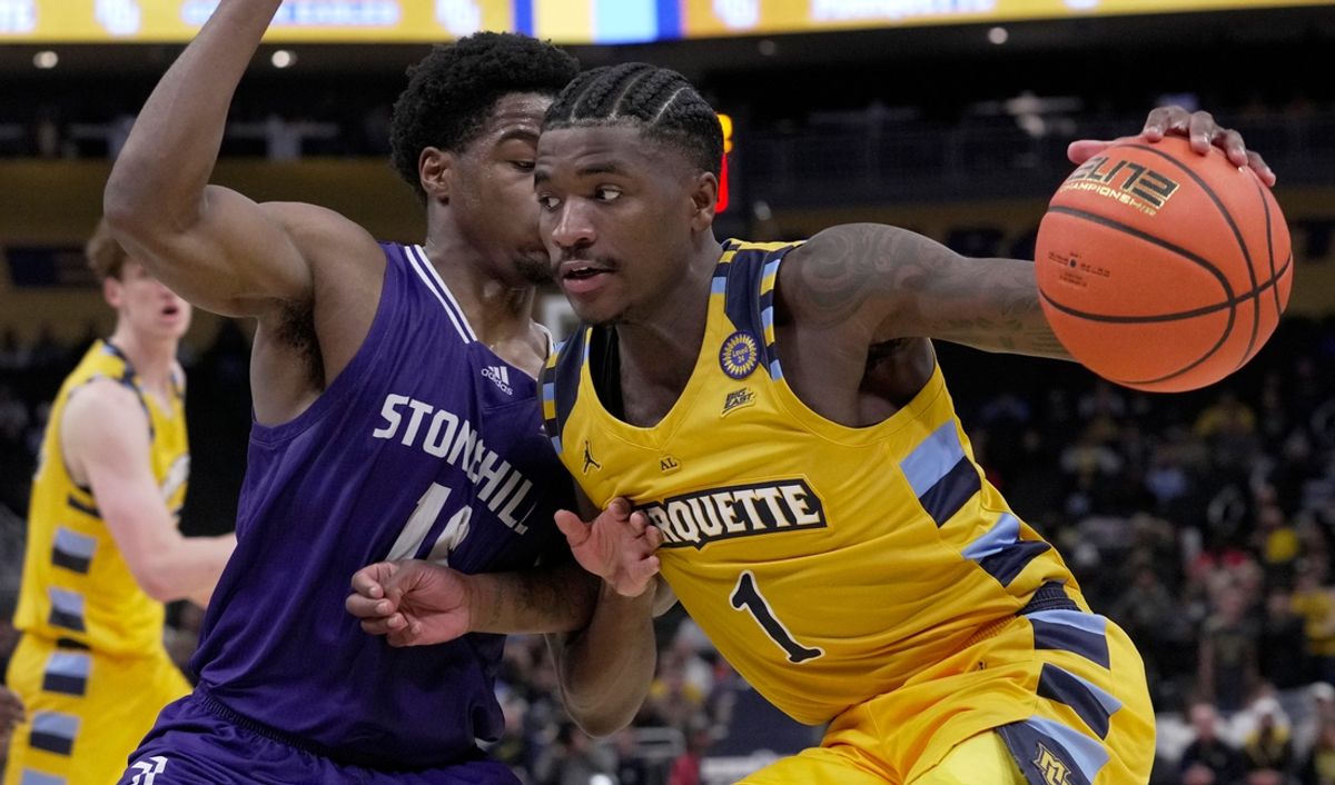 Marquette guard Kam Jones (1) makes a move on Stonehill guard Hermann Koffi (10) during the first half of their game Wednesday, November 27, 2024 at Fiserv Forum in Milwaukee, Wisconsin.