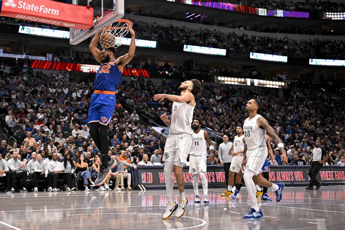 Nov 27, 2024; Dallas, Texas, USA; New York Knicks center Karl-Anthony Towns (32) dunks the ball as Dallas Mavericks center Dereck Lively II (2) and forward P.J. Washington (25) look on during the second half at the American Airlines Center. Mandatory Credit: Jerome Miron-Imagn Images
