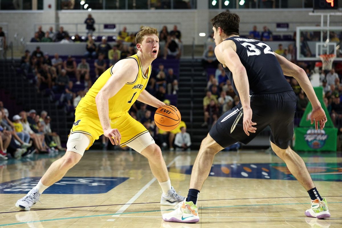 Nov 27, 2024; Fort Myers, Florida, USA; Michigan Wolverines center Danny Wolf (1) controls the ball from Xavier Musketeers forward Zach Freemantle (32) in the second half at Suncoast Credit Union Arena. Mandatory Credit: Nathan Ray Seebeck-Imagn Images
