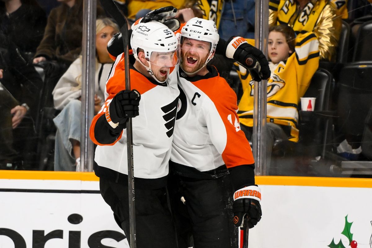 Nov 27, 2024; Nashville, Tennessee, USA;  Philadelphia Flyers center Sean Couturier (14) celebrates after his goal defenseman Rasmus Ristolainen (55) against the Nashville Predators during the the overtime period at Bridgestone Arena. Mandatory Credit: Steve Roberts-Imagn Images