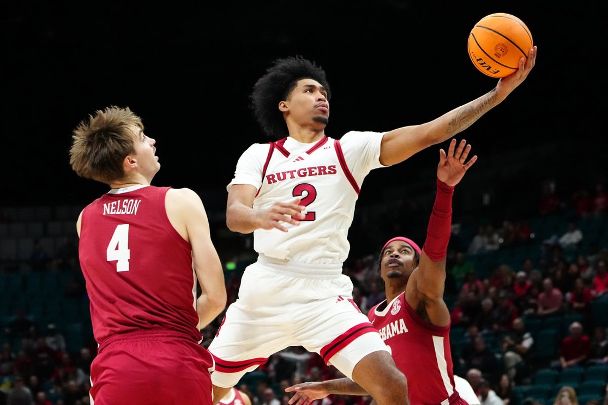 Nov 27, 2024; Las Vegas, Nevada, USA; Rutgers Scarlet Knights guard Dylan Harper (2) shoots between Alabama Crimson Tide forward Grant Nelson (4) and Alabama Crimson Tide forward Jarin Stevenson (15) during the first half at MGM Grand Garden Arena. Mandatory Credit: Stephen R. Sylvanie-Imagn Images
