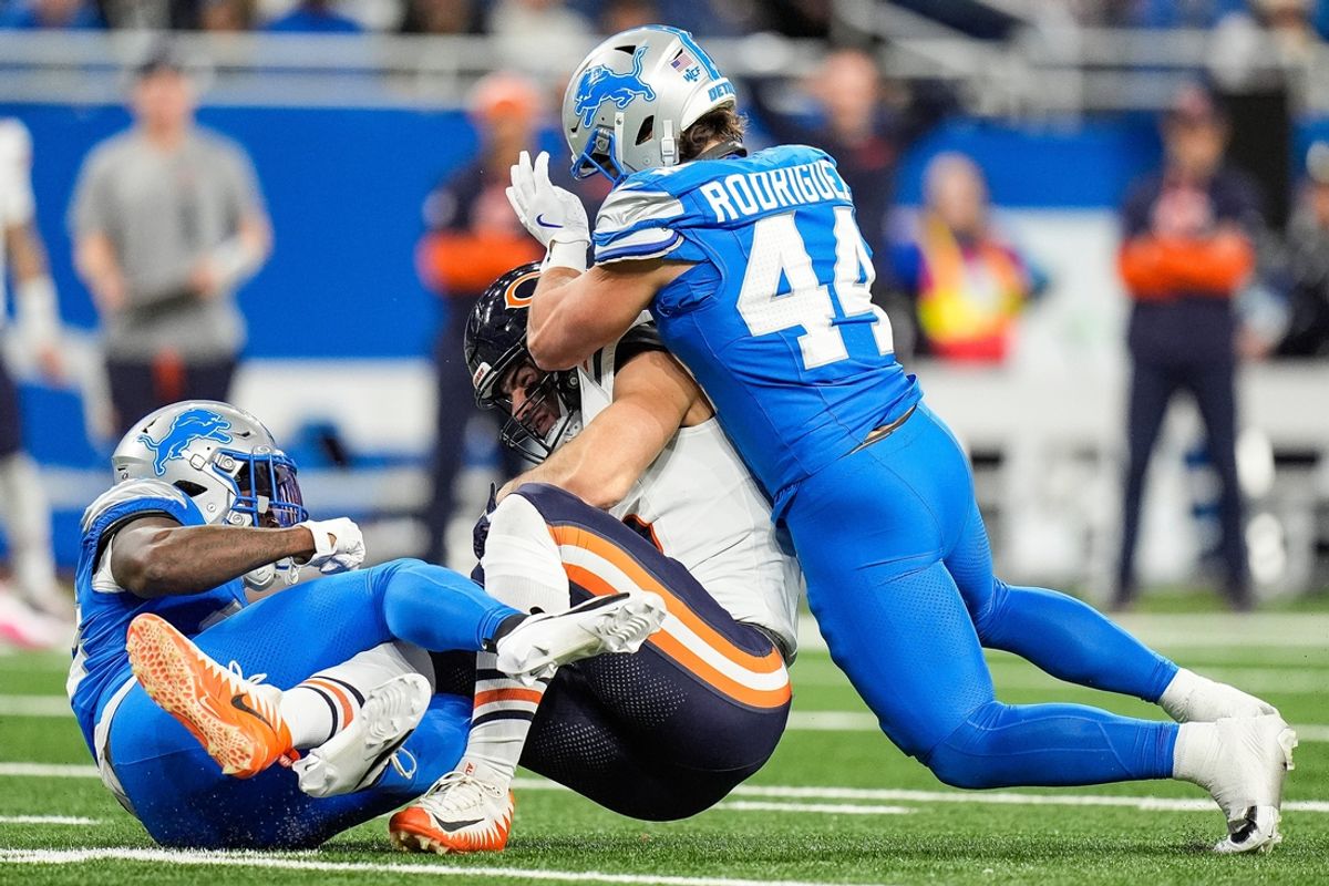 Detroit Lions linebacker Malcolm Rodriguez (44) tackles Chicago Bears tight end Cole Kmet (85) during the first half at Ford Field in Detroit on Thursday, Nov. 28, 2024.