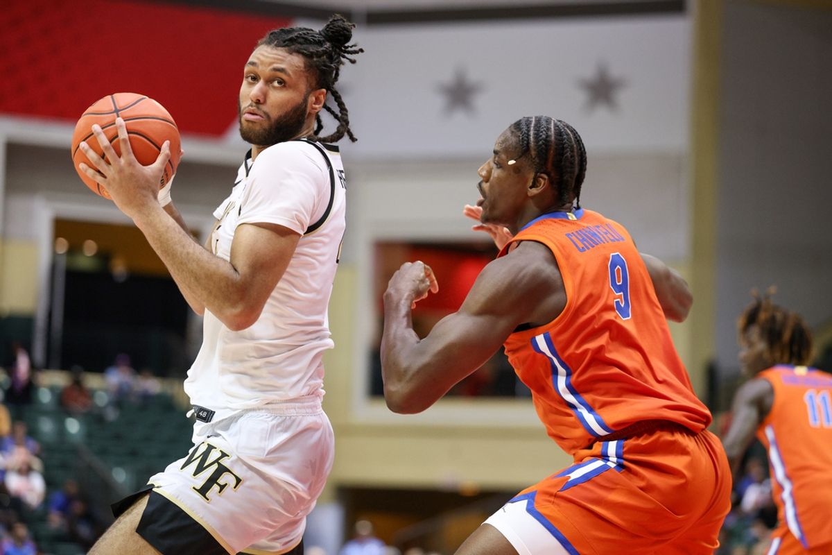 Nov 28, 2024; Orlando, Florida, USA; Wake Forest Demon Deacons forward Efton Reid III (4) is guarded by Florida Gators center Rueben Chinyelu (9) in the second half at ESPN Wide World of Sports Complex. Mandatory Credit: Nathan Ray Seebeck-Imagn Images