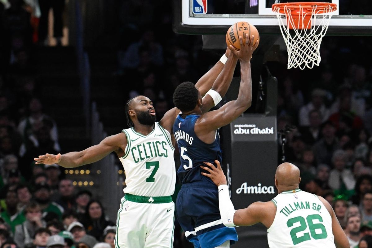 Nov 24, 2024; Boston, Massachusetts, USA; Boston Celtics guard Jaylen Brown (7) defends against Minnesota Timberwolves guard Anthony Edwards (5) during the first half at TD Garden. Mandatory Credit: Eric Canha-Imagn Images