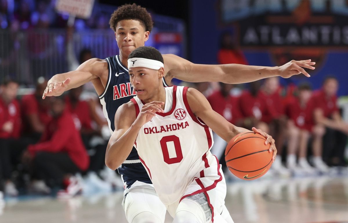 Nov 28, 2024;  Paradise Island, Bahamas, BHS; Oklahoma Sooners guard Jeremiah Fears (0) drives to the basket past Arizona Wildcats forward Carter Bryant (9) during the first half in the Imperial Arena at the Atlantis Resort.  Mandatory Credit: Kevin Jairaj-Imagn Images