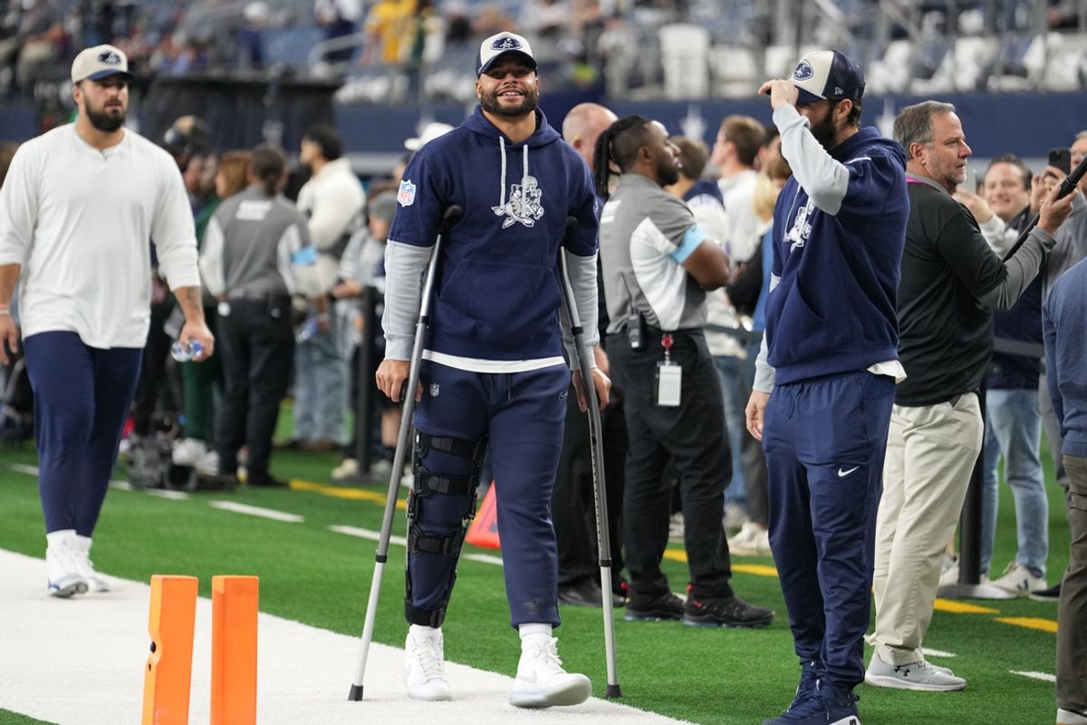 Nov 28, 2024; Arlington, Texas, USA;  Dallas Cowboys quarterback Dak Prescott (left) stands on crutches before the game against the New York Giants at AT&T Stadium. Mandatory Credit: Chris Jones-Imagn Images