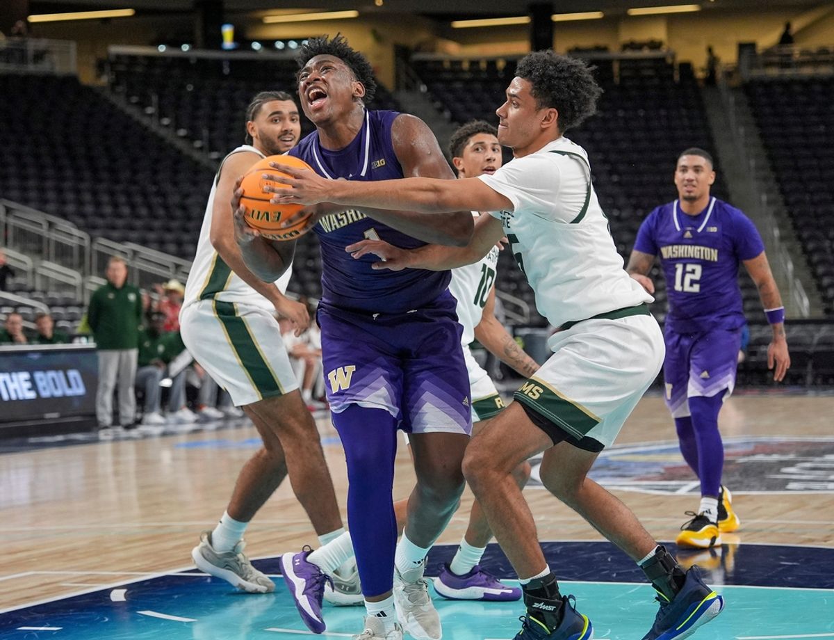 Great Osobor, 1, of the University of Washington gets fouled while driving against the Colorado St. defense during the 2024 Acrisure Mens Invitational in Palm Desert, Calif., Nov. 28, 2024.