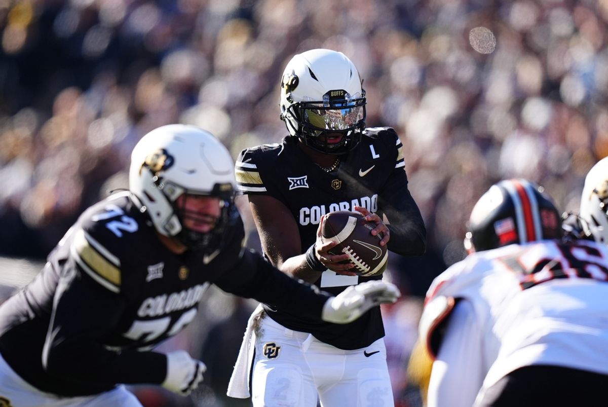 Nov 29, 2024; Boulder, Colorado, USA; Colorado Buffaloes quarterback Shedeur Sanders (2) takes a hike in the first quarter against the Oklahoma State Cowboys  at Folsom Field. Mandatory Credit: Ron Chenoy-Imagn Images