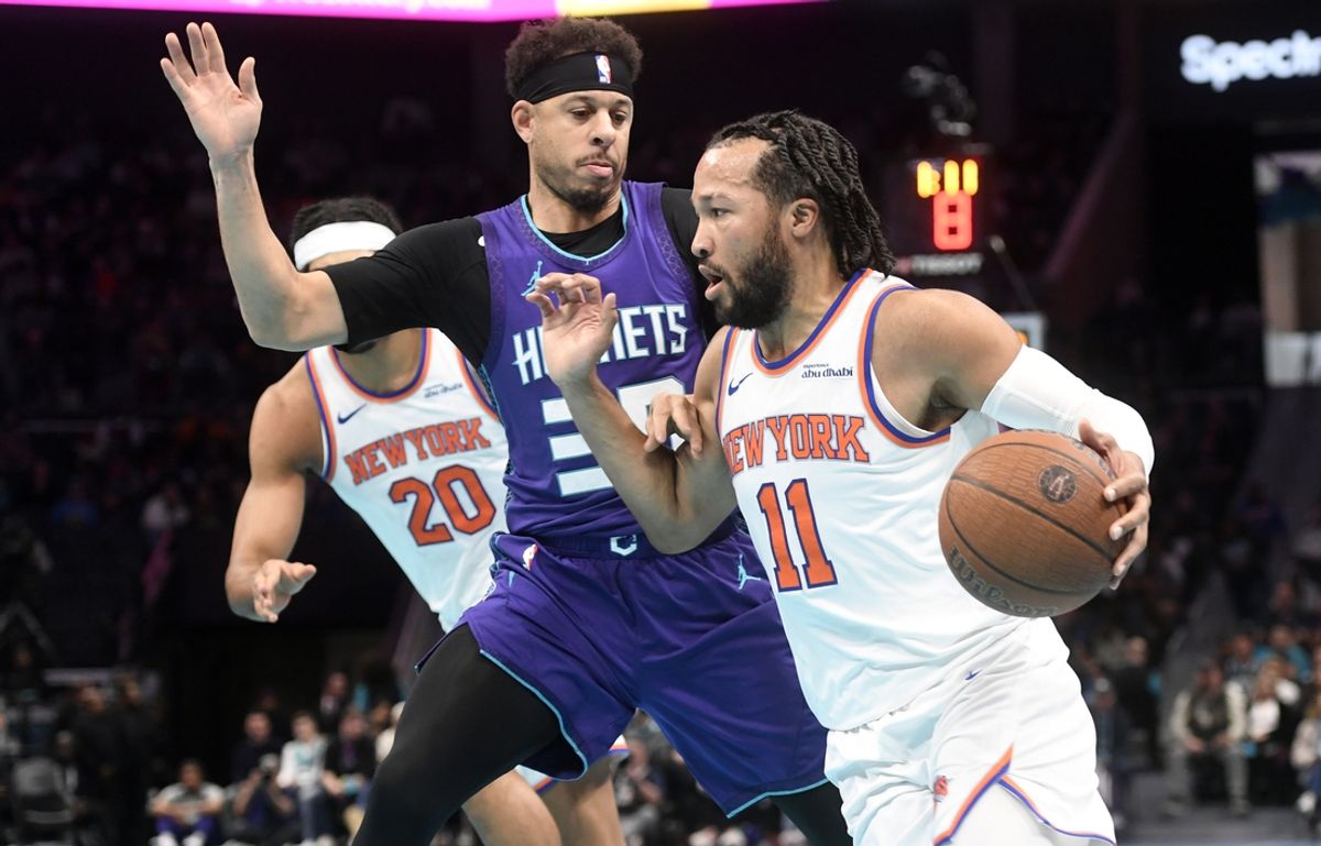 Nov 29, 2024; Charlotte, North Carolina, USA;  New York Knicks guard Jalen Brunson (11) drives past Charlotte Hornets guard Seth Curry (30) during the first half at the Spectrum Center. Mandatory Credit: Sam Sharpe-Imagn Images
