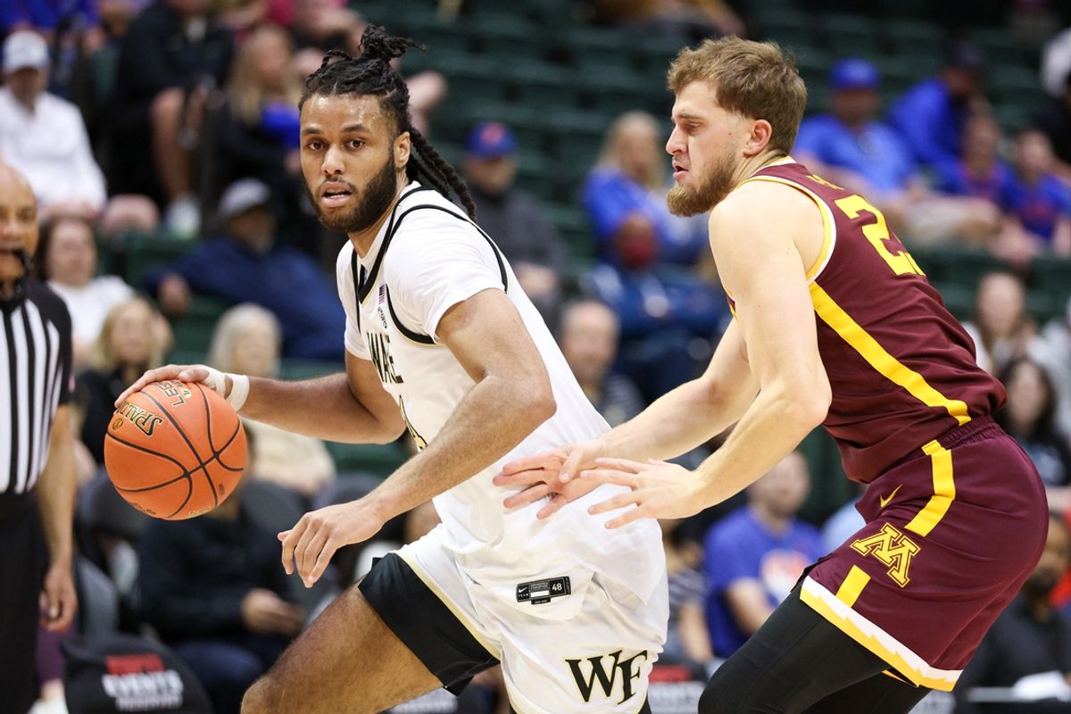 Nov 29, 2024; Orlando, Florida, USA; Wake Forest Demon Deacons forward Efton Reid III (4) is guarded by Minnesota Golden Gophers forward Parker Fox (23) in the first half  at ESPN Wide World of Sports Complex. Mandatory Credit: Nathan Ray Seebeck-Imagn Images