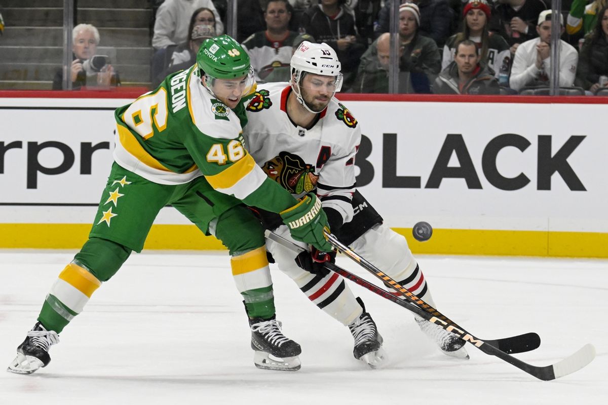 Nov 29, 2024; Saint Paul, Minnesota, USA;  Minnesota Wild defenseman Jared Spurgeon (46) and Chicago Blackhawks forward Jason Dickinson (16) battle for the puck during the first period at Xcel Energy Center. Mandatory Credit: Nick Wosika-Imagn Images