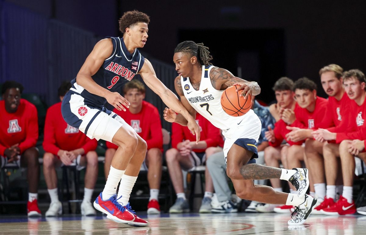 Nov 29, 2024; Paradise Island, Bahamas, BHS;  West Virginia Mountaineers guard Javon Small (7) dribbles as Arizona Wildcats forward Carter Bryant (9) defends during the first half at Imperial Arena at the Atlantis resort.  Mandatory Credit: Kevin Jairaj-Imagn Images