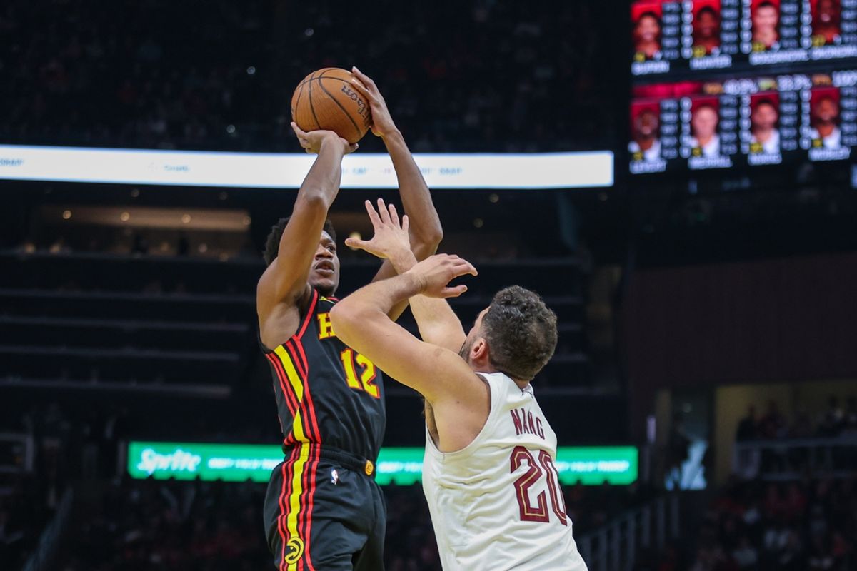 Nov 29, 2024; Atlanta, Georgia, USA; Cleveland Cavaliers forward Georges Niang (20) attempts to block shot against Atlanta Hawks forward De'Andre Hunter (12) during the first quarter at State Farm Arena. Mandatory Credit: Jordan Godfree-Imagn Images