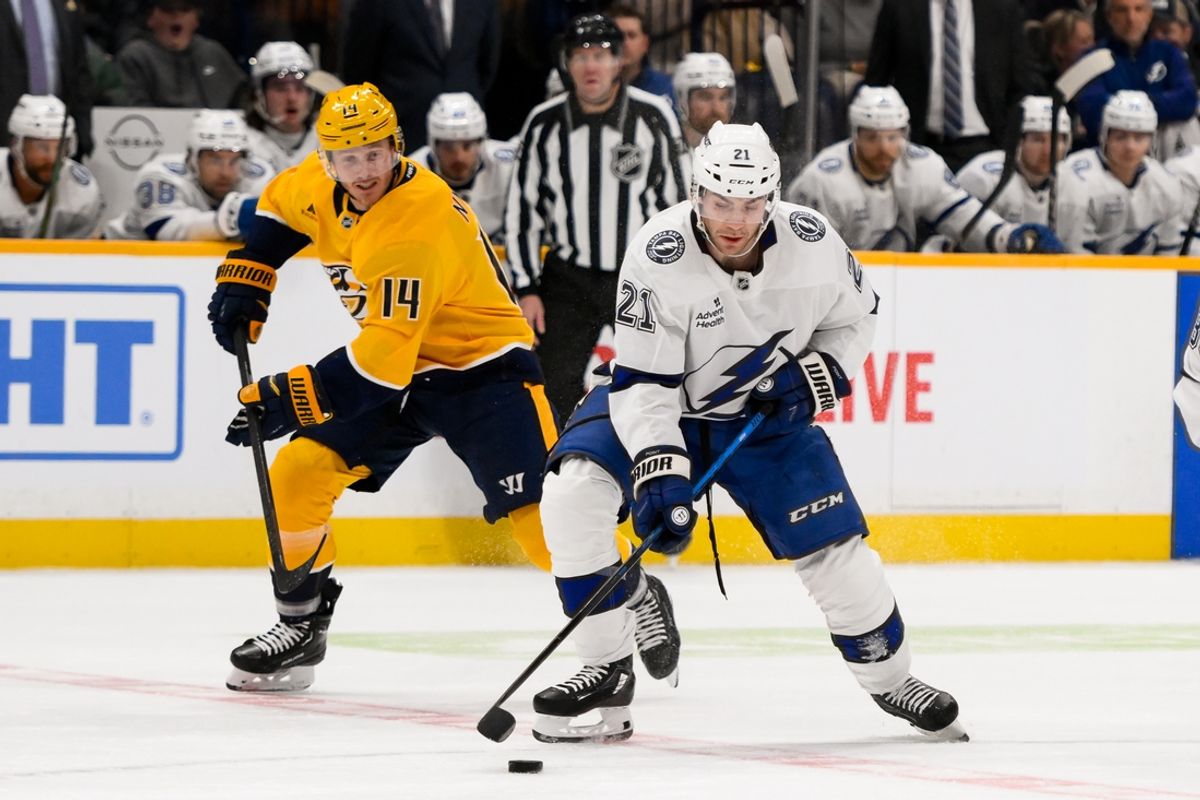 Nov 29, 2024; Nashville, Tennessee, USA;  Tampa Bay Lightning center Brayden Point (21) skates with the puck against the Nashville Predators during the first period at Bridgestone Arena. Mandatory Credit: Steve Roberts-Imagn Images