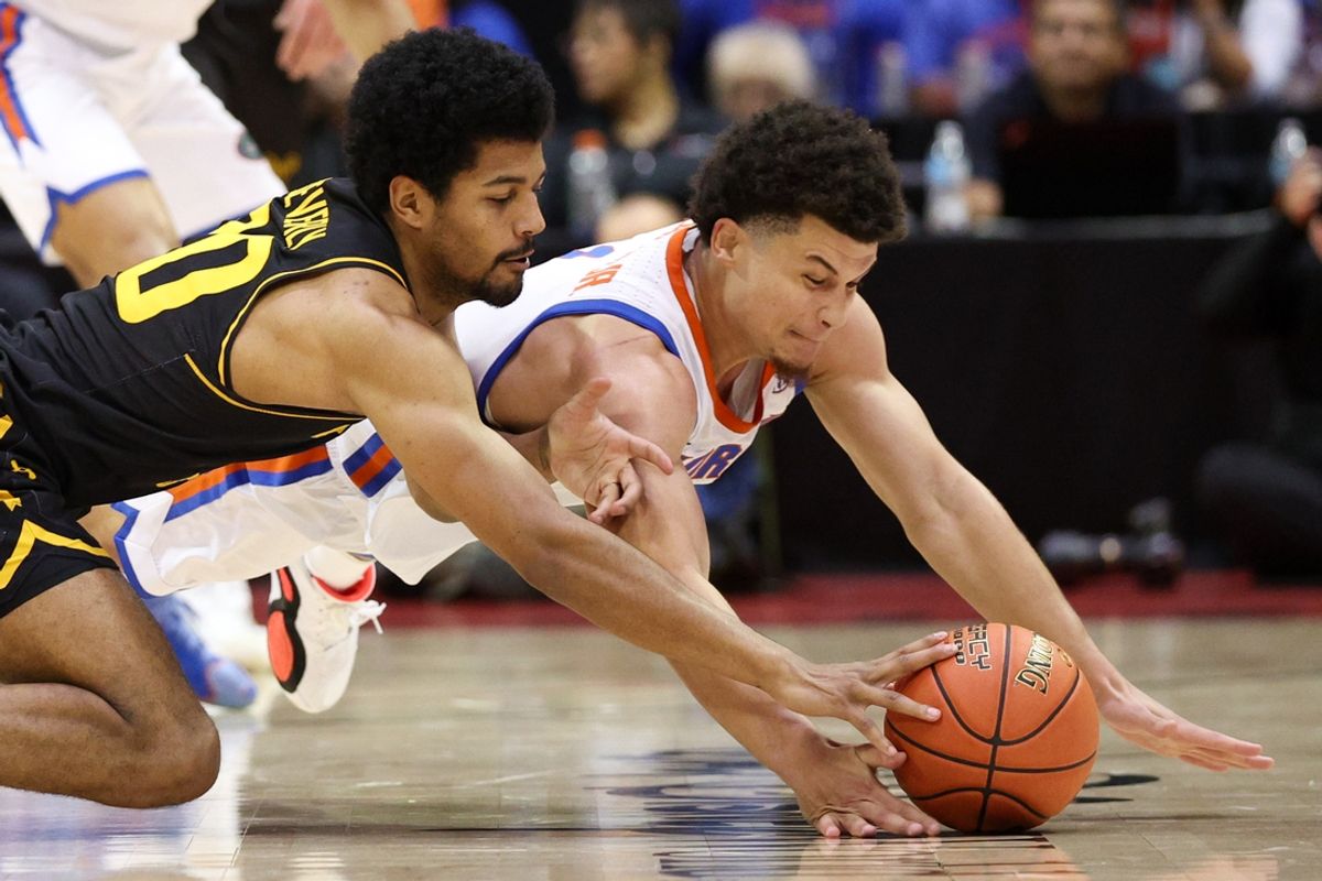 Nov 29, 2024; Orlando, Florida, USA;  Wichita State Shockers guard Harlond Beverly (20) and Florida Gators guard Walter Clayton Jr. (1) fight for a loose ball in the first half at ESPN Wide World of Sports Complex. Mandatory Credit: Nathan Ray Seebeck-Imagn Images