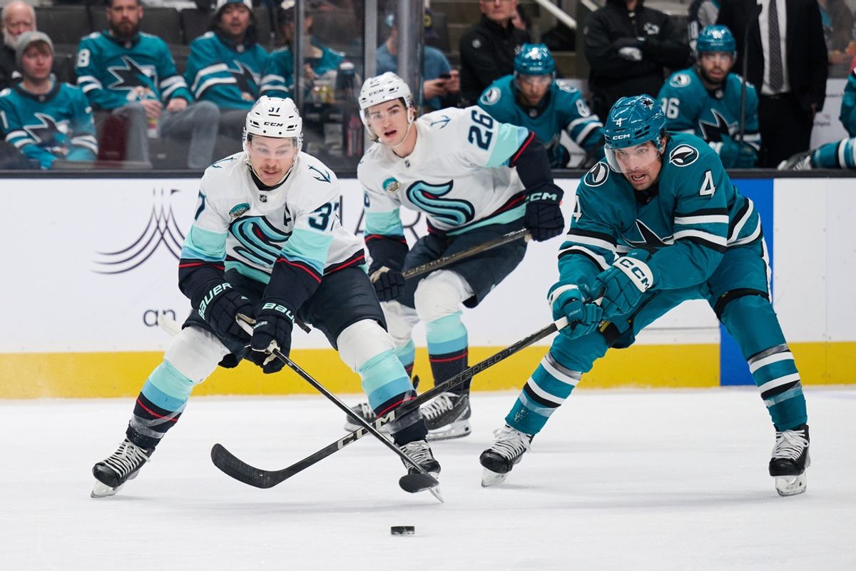 Nov 29, 2024; San Jose, California, USA; Seattle Kraken goaltender Philipp Grubauer (31) plays the puck against San Jose Sharks defenseman Cody Ceci (4) during the first period at SAP Center at San Jose. Mandatory Credit: Robert Edwards-Imagn Images