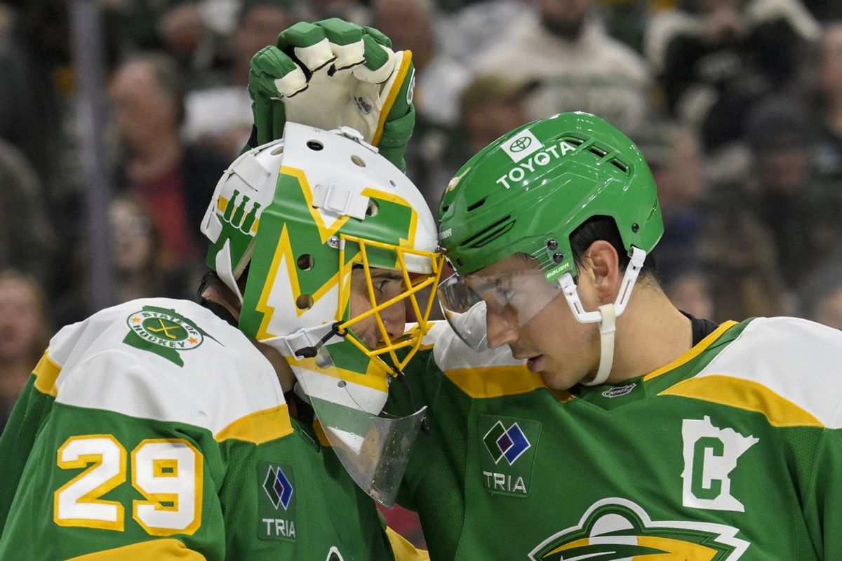 Nov 29, 2024; Saint Paul, Minnesota, USA;  Minnesota Wild goalie Marc-Andre Fleury (29) and defenseman Jared Spurgeon (46) celebrate a victory over the Chicago Blackhawks at Xcel Energy Center. Mandatory Credit: Nick Wosika-Imagn Images