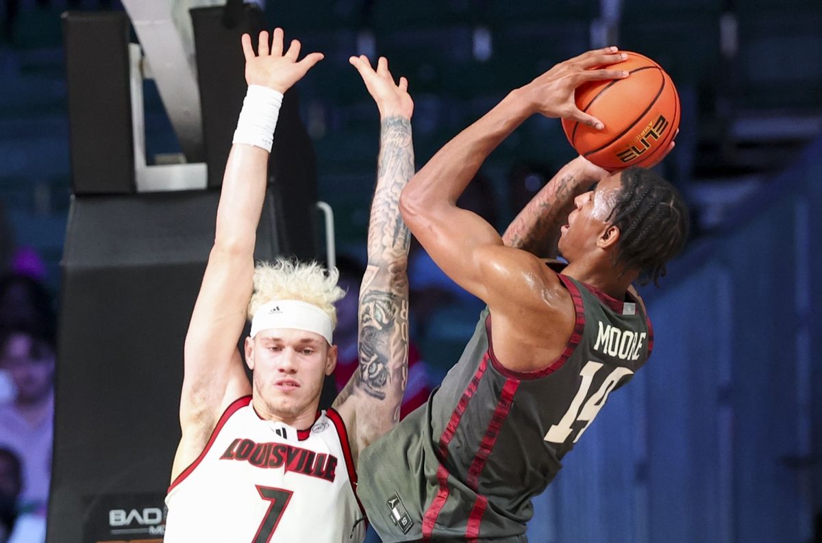 Nov 29, 2024; Paradise Island, Bahamas, BHS;  Oklahoma Sooners forward Jalon Moore (14) shoots over Louisville Cardinals forward Kasean Pryor (7) during the first half at Imperial Arena at the Atlantis resort.  Mandatory Credit: Kevin Jairaj-Imagn Images